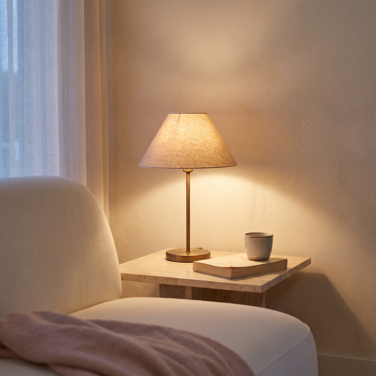 Warm lamp illuminating a quiet cream living-room corner